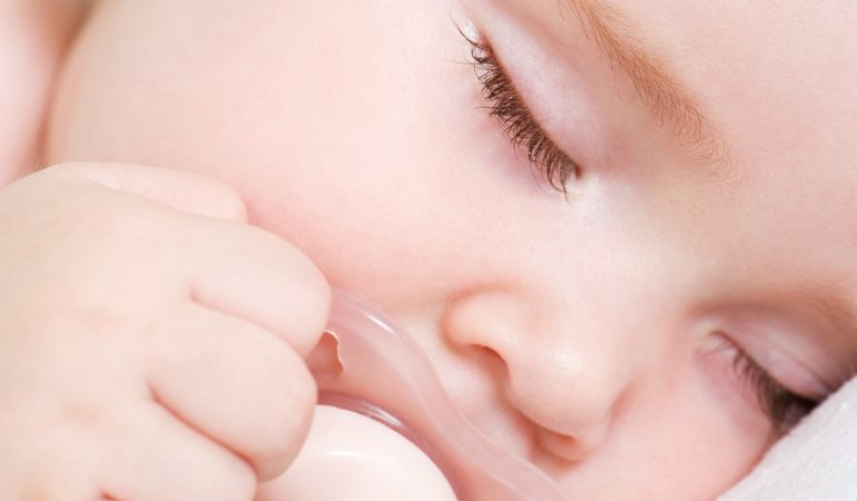 Newborn beautiful baby sleeping. Closeup portrait